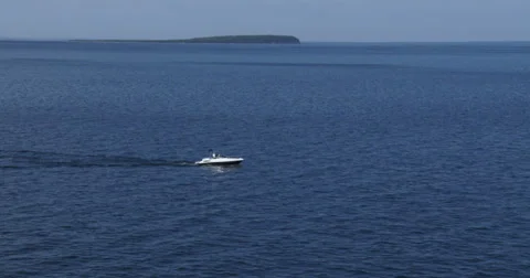 Boat navigating on calm lake Stock Footage 39570663