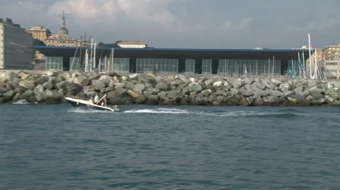 Boat navigating in front of the Genoa Boat Show Stock Footage 36920268