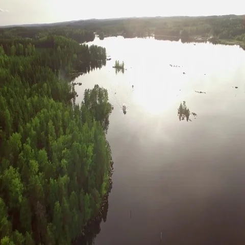 Boat navigating on a narrow waterway between rocks at a Nordic lake Stock-Footage 69526626