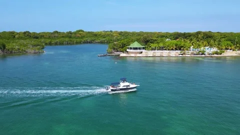 Boat Navigating Through Clear Water Near Islands Stock Footage 330449848
