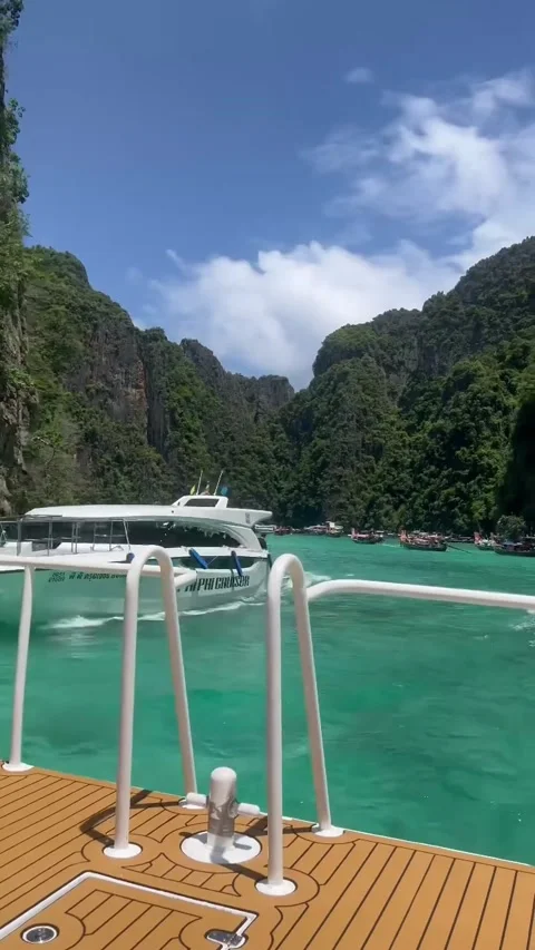 Boat Navigating through the Emerald Waters of Pileh Lagoon Stock Footage 339876681