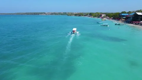 Boat navigating turquoise waters of Baru, Colombia Stock Footage 330449200