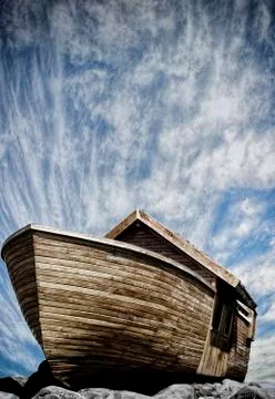 Boat Of Noah on the rocks with cloudscape background Stock Photos