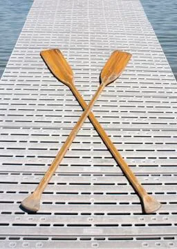 Boat oars on a dock Stock Photos