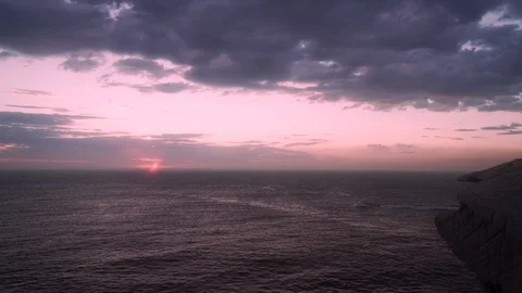 Boat on ocean at dawn from headland Stock Footage 107054025