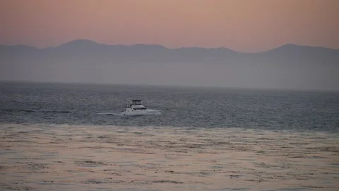 A boat in the ocean with mountains in the background Stock Footage 171734177