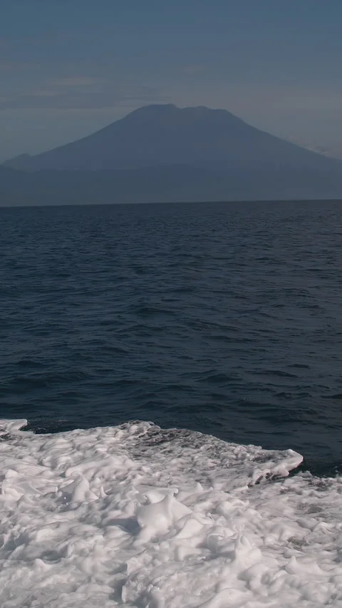A boat in the ocean of a volcano Stock Footage 276695159