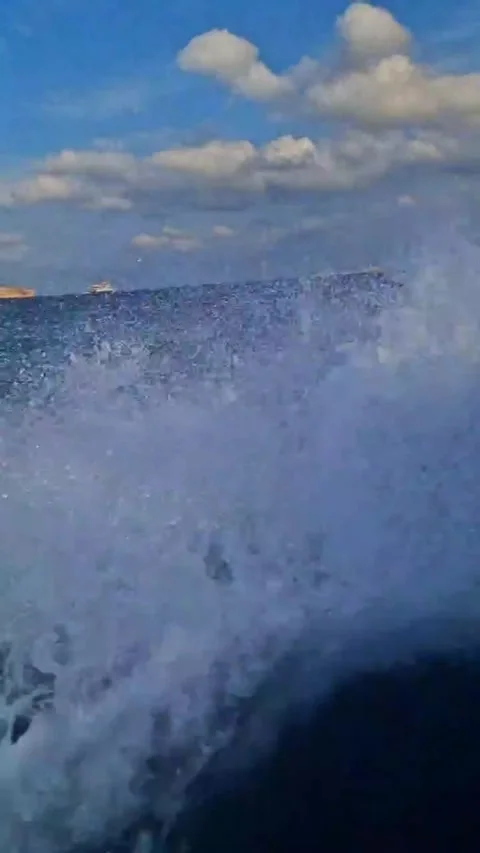 Boat on the Open Sea Waves Forming Gracefully Behind Stock Footage 289648256