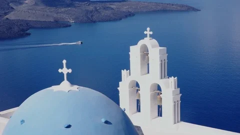 Boat a passes behind the three bells in fira, santorini Stock Footage 72765774