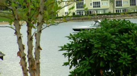 Boat Passes by Shore of Lake in New Hampshire Stock Footage