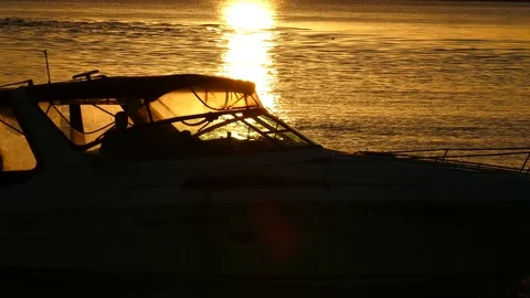 Boat Passes Through Golden Sunset Stock Footage 76201228