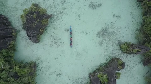 A boat passes through several small karst islands in Raja Ampat,Papua Video stock 157051081