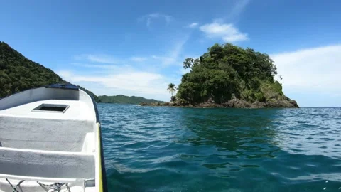 Boat passing close to tropical small island - Sapzurro, Colombia 4K Stock Footage 166460496