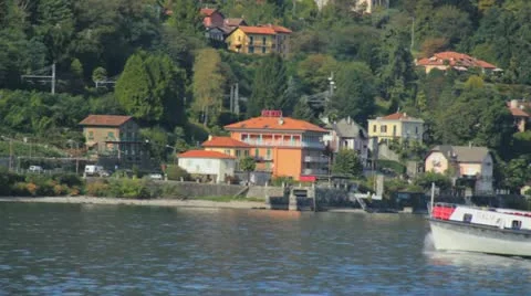 Boat passing by right to left with backround of houses Stock Footage 21893347