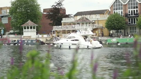 Boat passing in the river with moored vessels in the background Stock-Footage 77479717