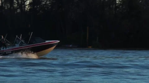 Boat passing by in the river at sunset Stock Footage 196447415