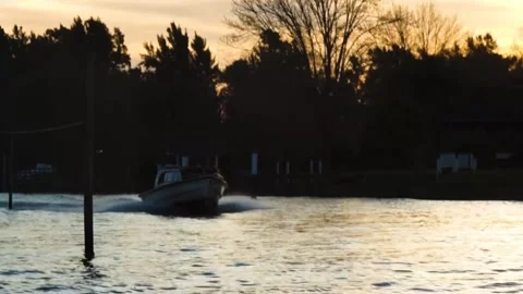 Boat passing by in the river sunset Stock Footage 196447435