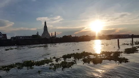 Boat passing by the temple at the sunset time, Thailand Stockbeeldmateriaal 109541410