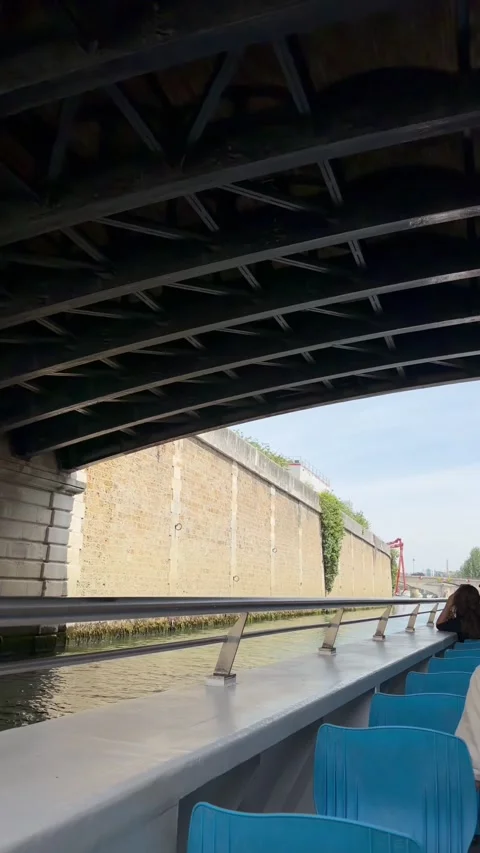 Boat passing under a bridge structure on the Seine River in Paris. Stock Footage 347687868