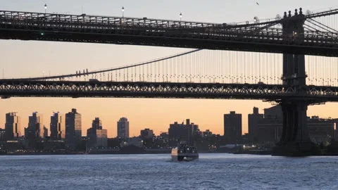 Boat passing under Brooklyn Bridge at sunrise Stock Footage 344958766