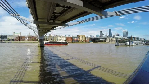 Boat passing under Millennium bridge on a summer day Stock Footage 78982927