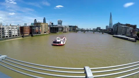 Boat passing under Millennium Bridge with a view to The Shard, London Stock Footage 79507412