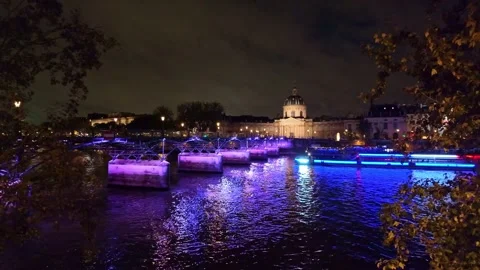 Boat passing under Pont des Arts bridge crossing Seine river, Paris at Stock Footage 292863846