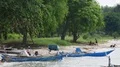 Boat people and anchored traditional indonesia small ships at beach 4k or 4k+ Resolution