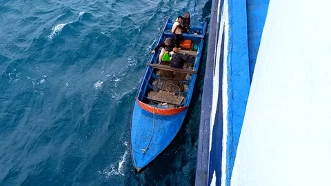 The boat picking up the crew Stock Footage 219469344