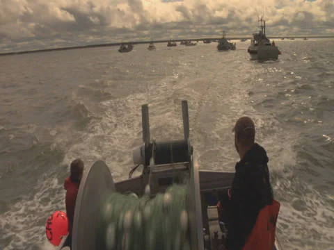 Boat plays out nets 1 Stock Footage 29280106