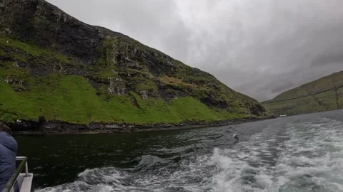 Boat POV sailing close to dramatic Vestmanna bird cliffs, Faroe Islands Stock Footage 339270002