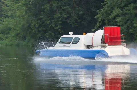 Boat with propeller moves down river Stock Photos
