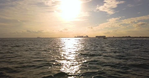 Boat Pulling A Couple Parasailing Right To Left During Sundown Stock Footage 105423177