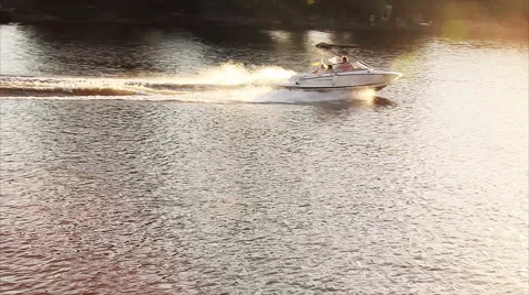 The boat pulls a man in the circle on the river Stock Footage 67570545