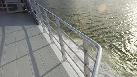 Boat railing or handrail on ship or ferry sailing in a lake in sunset or sunrise Stock Footage 289416741