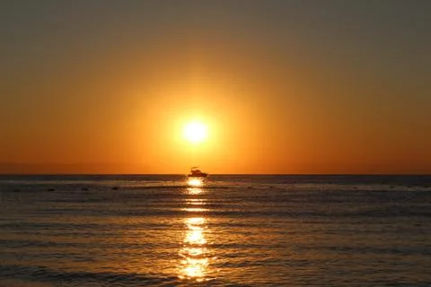 The boat in the rays of the rising sun Stock Photos