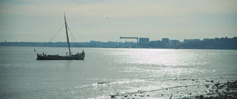 Boat reaching the coast at sunset Stock Footage 151390723