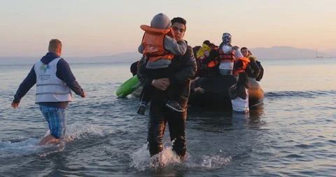 Boat refugees helped ashore on the island of Kos, Greece, 4k Stock Footage
