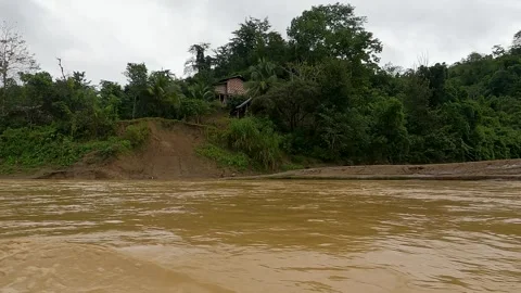 Boat ride in muddy stream between green mountains Stock Footage 273635776