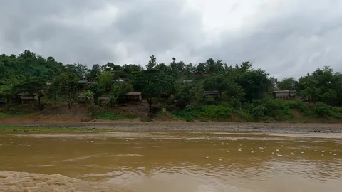 Boat ride in muddy stream between green mountains Stock Footage 273635822