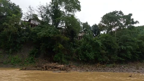 Boat ride in muddy stream between green mountains Stock Footage 273635831