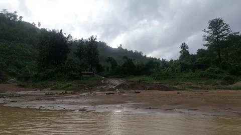 Boat ride in muddy stream between green mountains Stock Footage 273635933