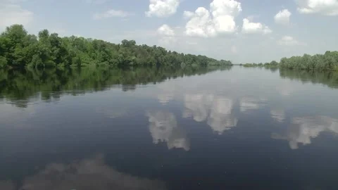 A boat ride on the river. Reflection of trees in the river. Video stock 120291637