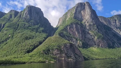Boat ride through the steep cliffs of Western Brook Pond Stock Footage 346368375