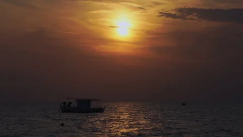 A boat rocks on calm waves Stockbeeldmateriaal 258961608