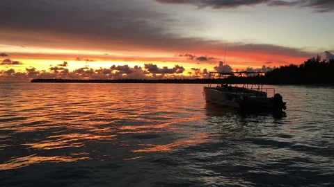 The boat rocks on the waves in the rays of the sunset Stock Footage 90753772
