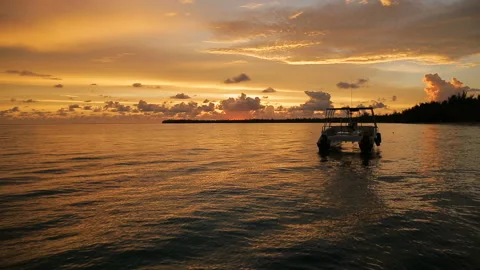 The boat rocks on the waves in the rays of the sunset Stock Footage 90756065