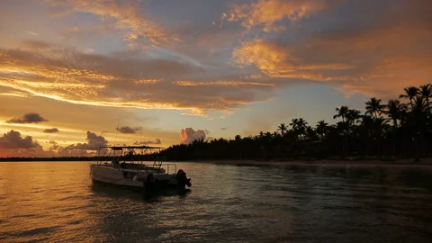 The boat rocks on the waves in the rays of the sunset Stock Footage 90757669