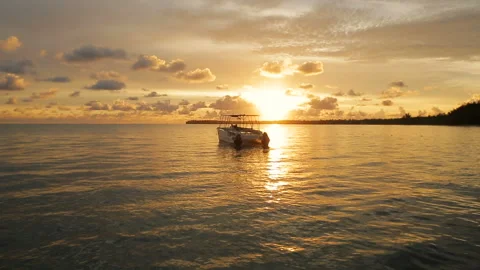 The boat rocks on the waves in the rays of the sunset Stock Footage 90758669