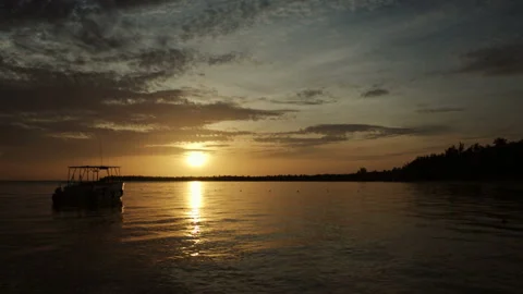 The boat rocks on the waves in the rays of the sunset Stock Footage 90759168